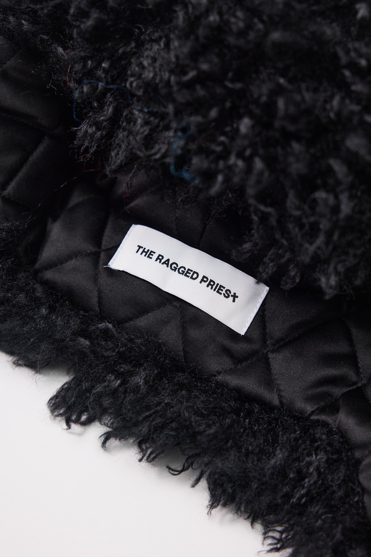 Black shaggy faux fur trapper hat with pom poms