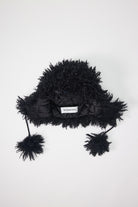 Black shaggy faux fur trapper hat with pom poms