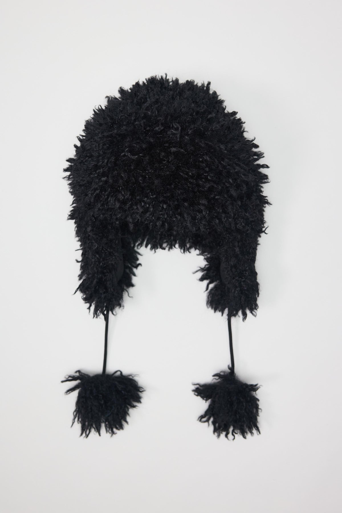 Black shaggy faux fur trapper hat with pom poms