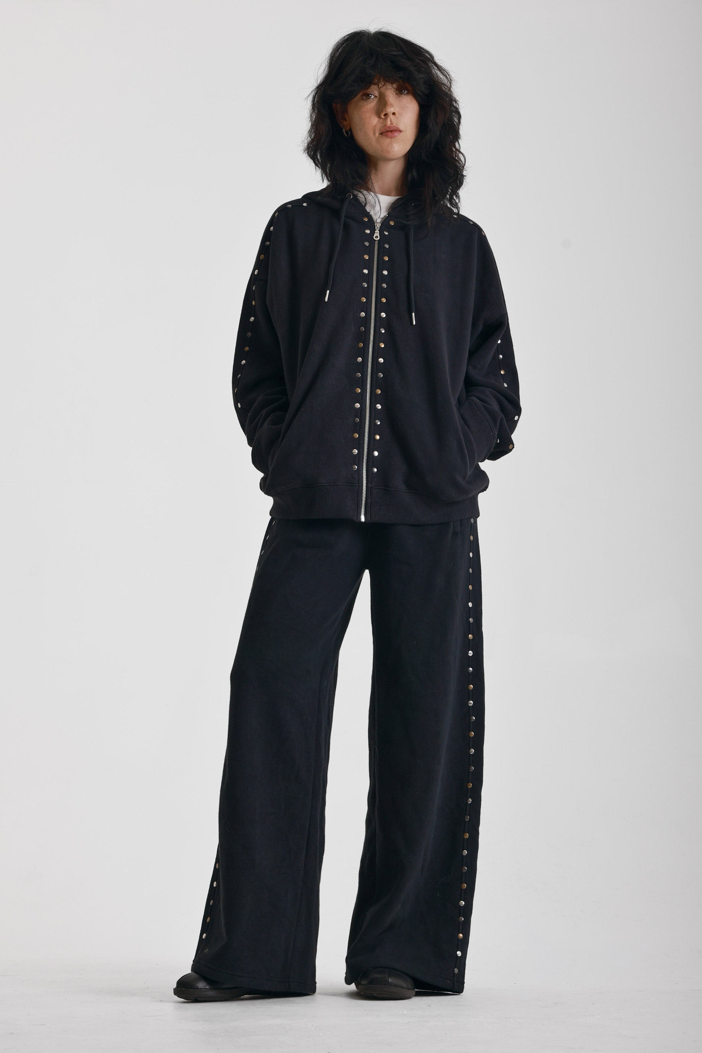 Washed black oversized zip up hoodie with mixed metal stud detail, worn by model