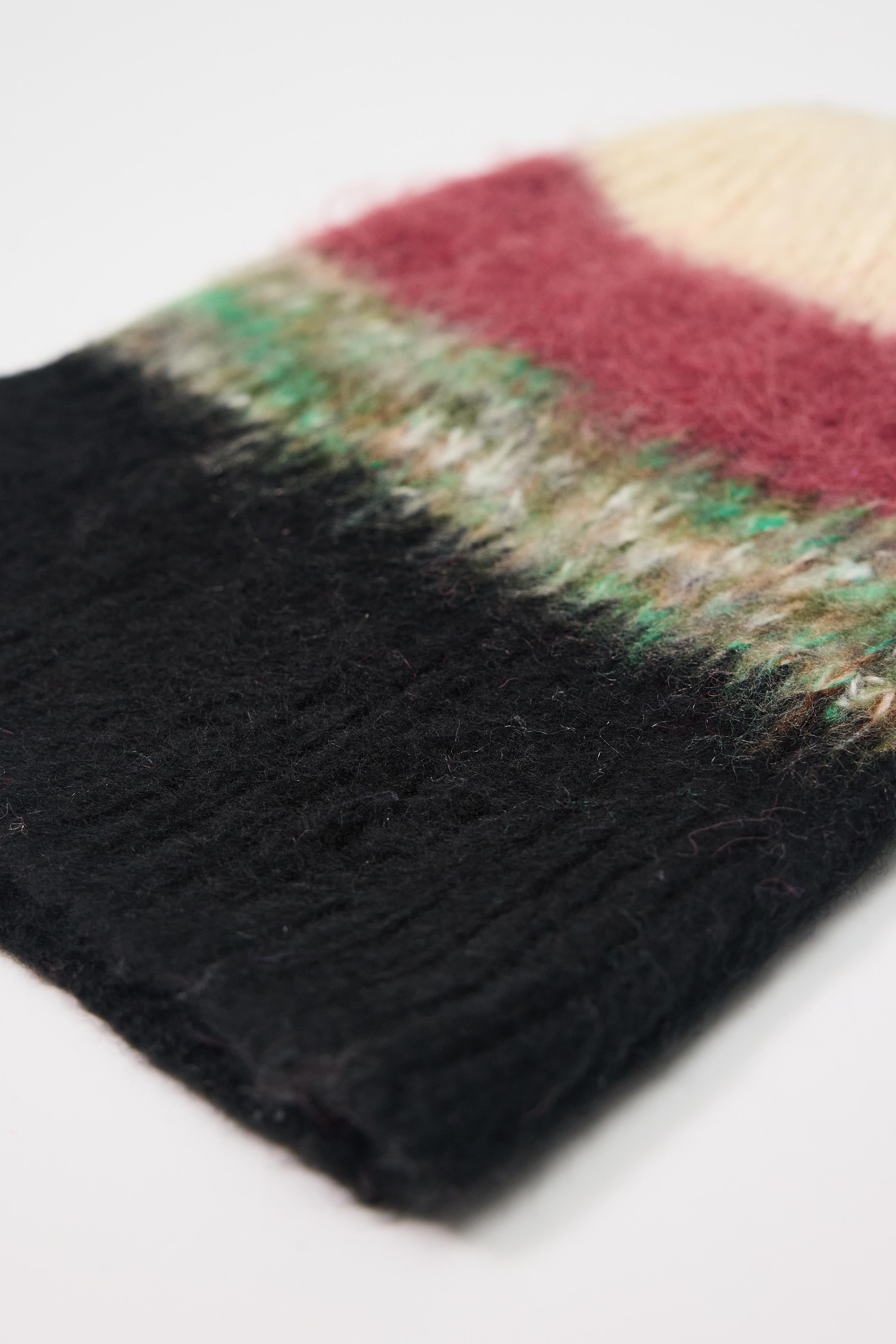 Black, green, pink and ecru textured fuzzy stripe knit beanie winter hat.