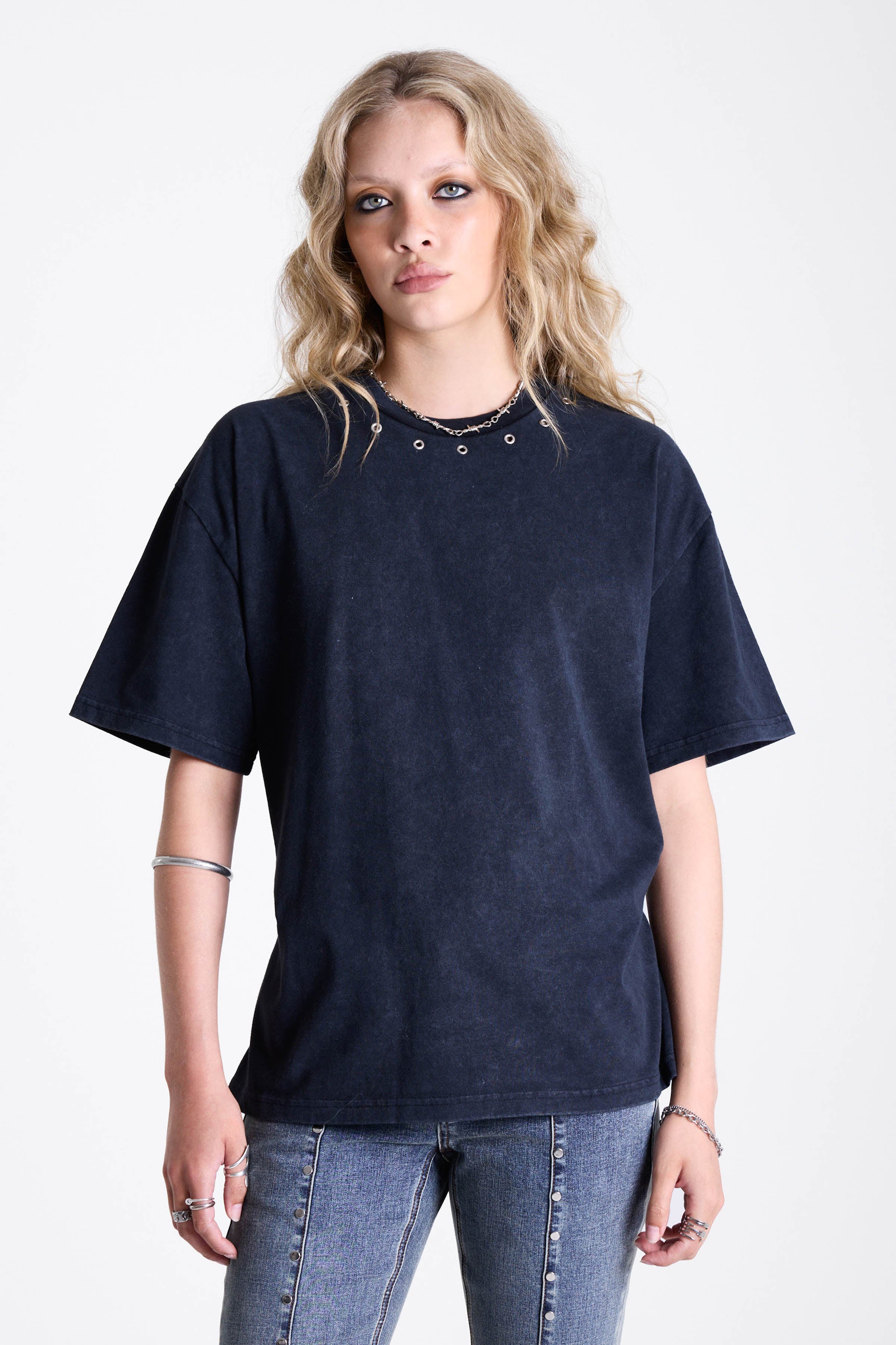 Acid wash black oversized t-shirt with silver eyelets and open back, worn by model