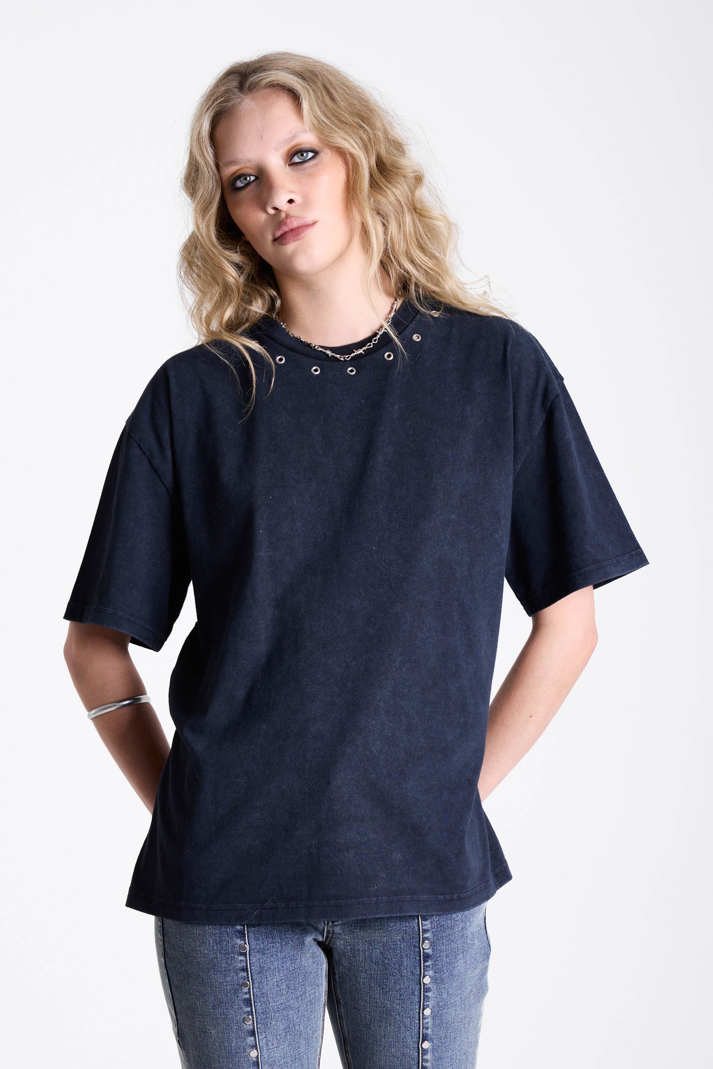 Acid wash black oversized t-shirt with silver eyelets and open back, worn by model