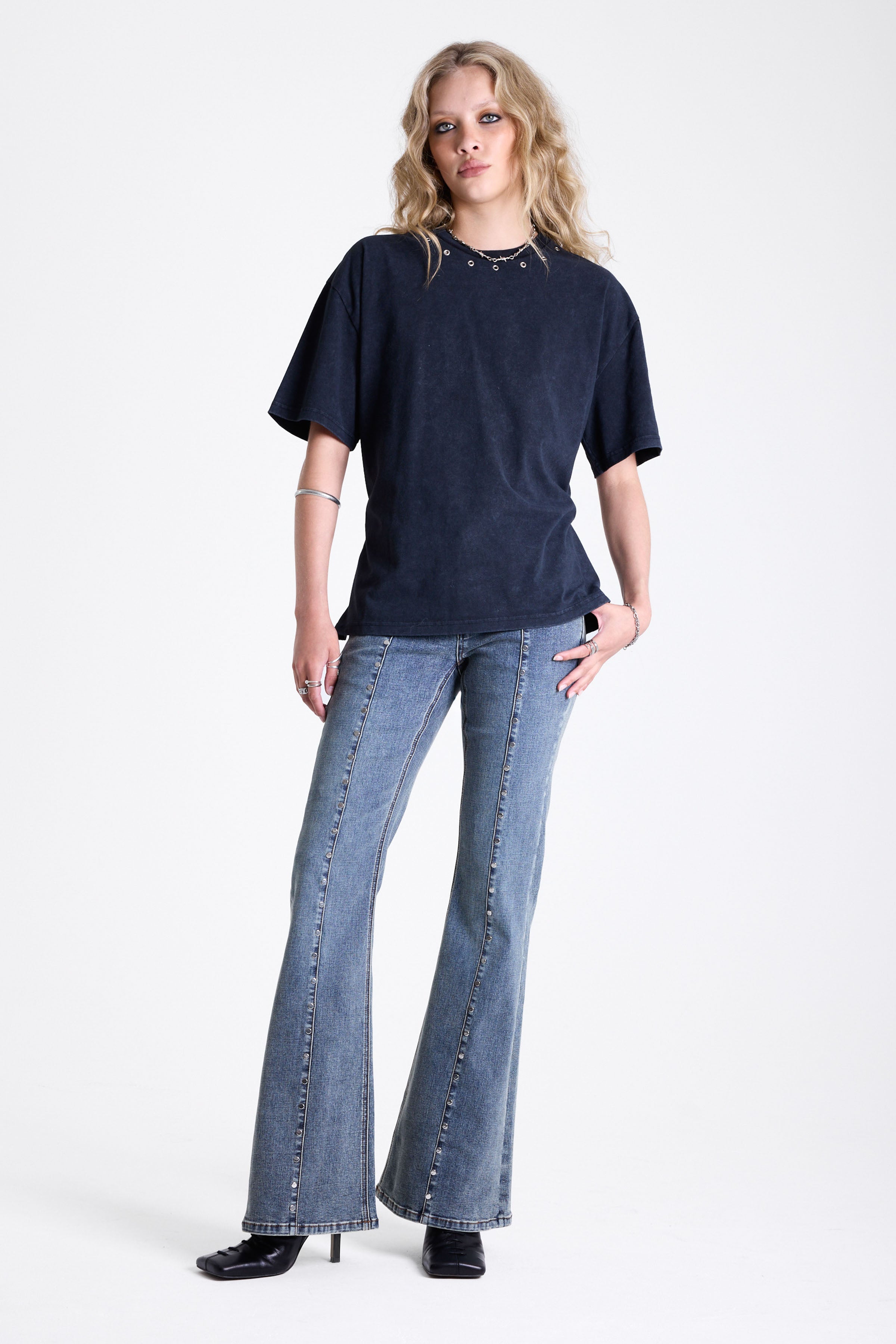 Acid wash black oversized t-shirt with silver eyelets and open back, worn by model