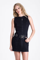 Black denim mini dress with silver trigger clasp eyelet detail belt, worn by model
