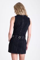 Black denim mini dress with silver trigger clasp eyelet detail belt, worn by model