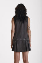 Grey pinstripe zip through mini dress with pleated skirt and silver eyelet belt and D-ring hardware, worn by model