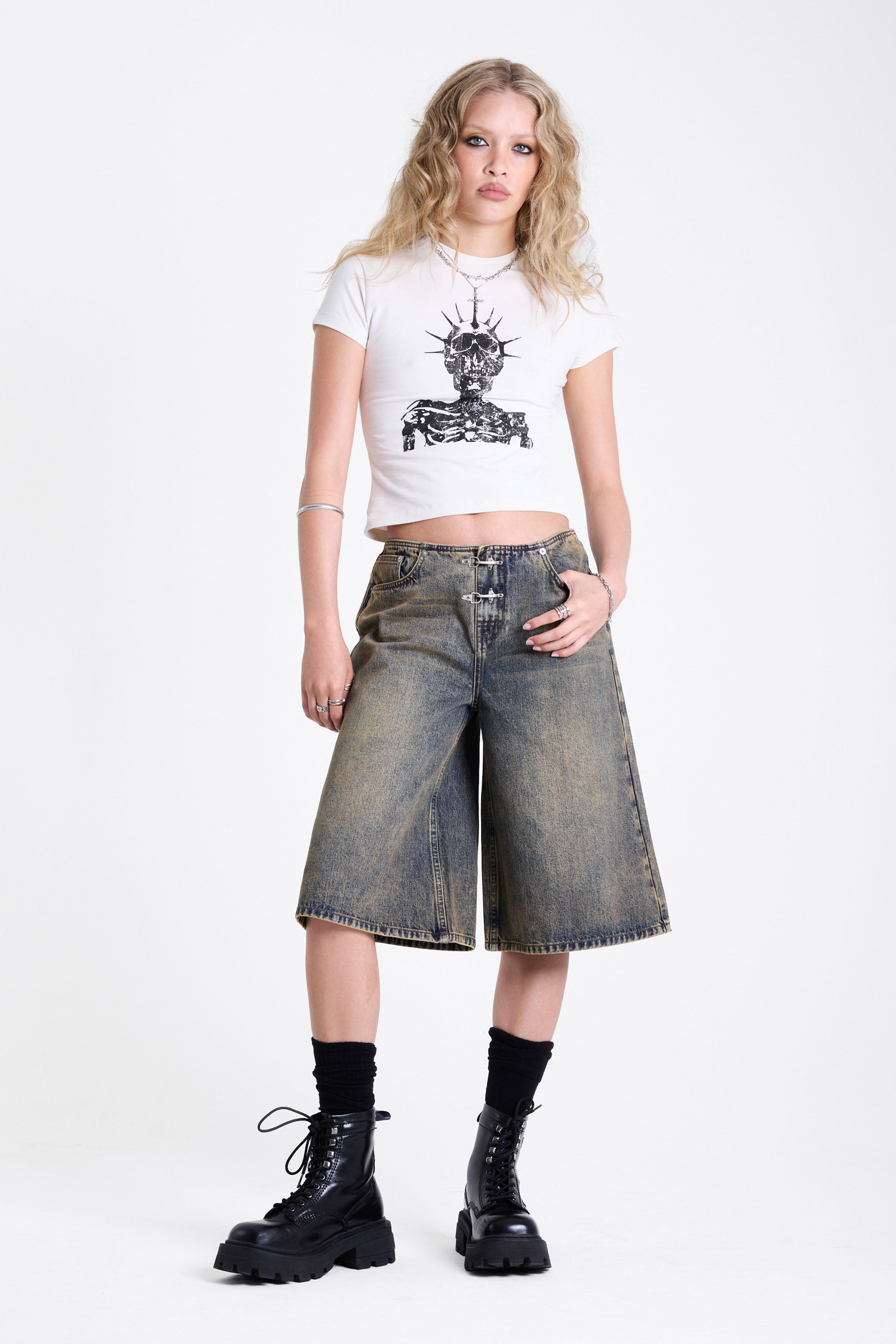 White shrunken baby t-shirt with distressed skull skeleton graphic print, worn by model