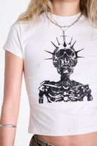 White shrunken baby t-shirt with distressed skull skeleton graphic print, worn by model